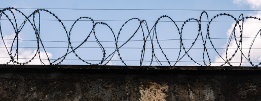 Barbed wire across a wall