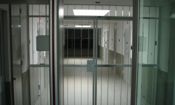 An image of a prison corridor with bars